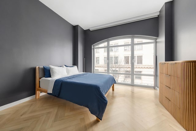 bedroom featuring baseboards and access to exterior