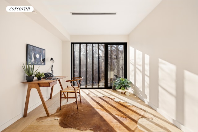interior space featuring wood finished floors and baseboards