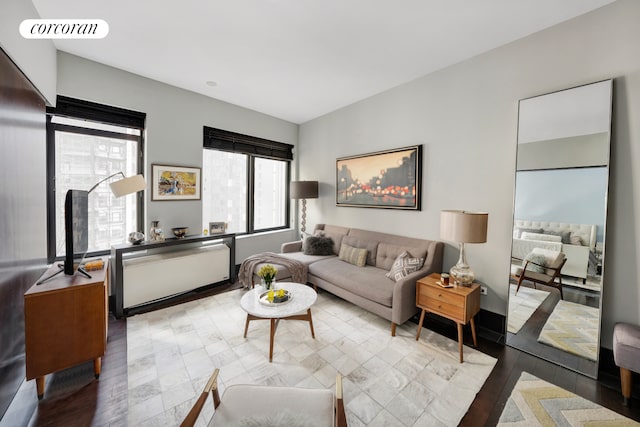 living area featuring visible vents and wood finished floors