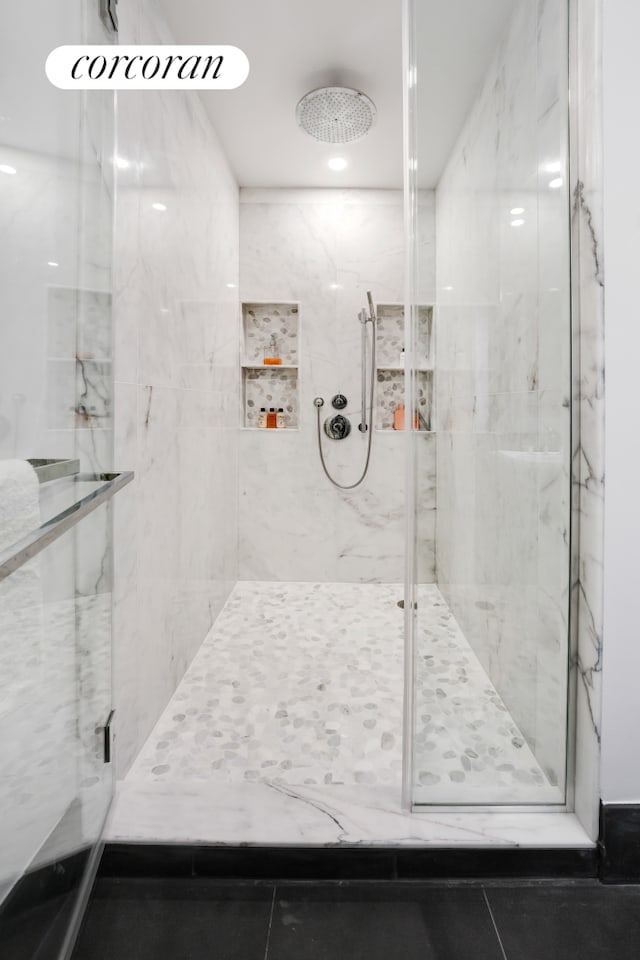40 Broad St Unit 22F, New York City, NY 10004 - full bath featuring a marble finish shower and tile patterned flooring