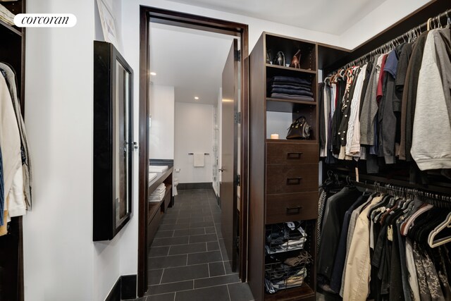 40 Broad St Unit 22F, New York City, NY 10004 - spacious closet with dark tile patterned flooring