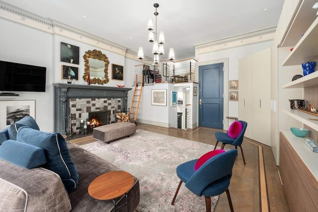 living area featuring a tiled fireplace and an inviting chandelier