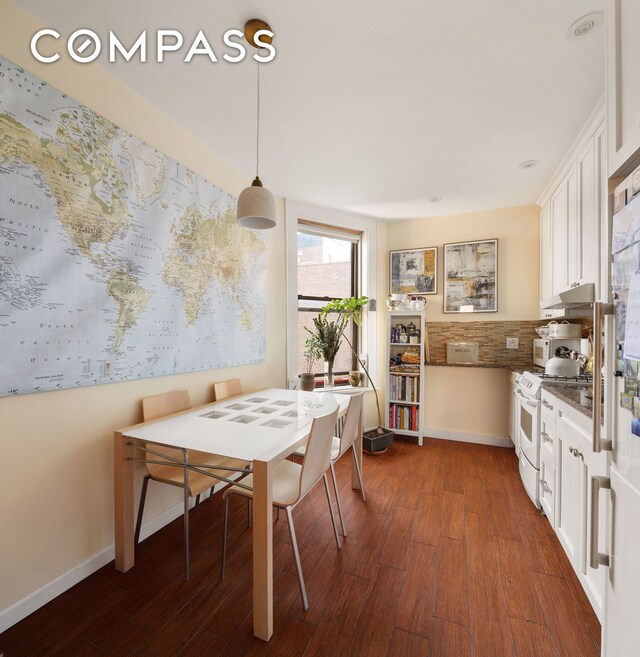 dining space with dark wood-style floors and baseboards