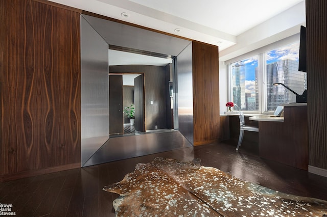 hallway with hardwood / wood-style flooring