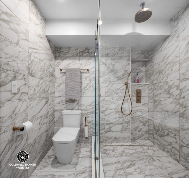 190 E 72nd St Unit 31B, New York City, NY 10021 - bathroom featuring marble finish flooring, a tile shower, toilet, and tile walls