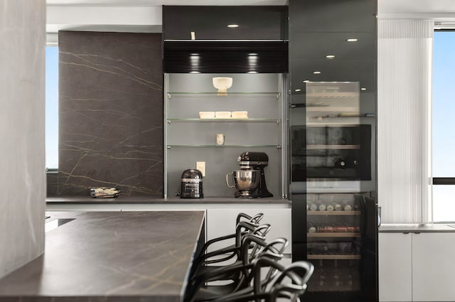 190 E 72nd St Unit 31B, New York City, NY 10021 - bar with plenty of natural light and tasteful backsplash