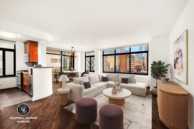 400 E 70th St Unit 1001, New York City, NY 10021 - living area featuring dark wood-style flooring, a chandelier, and baseboards