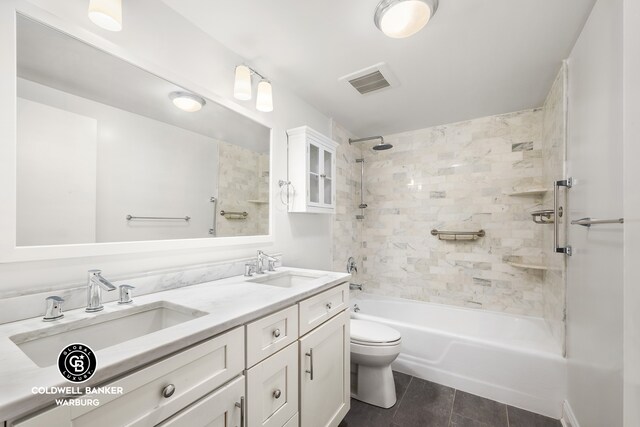 bathroom featuring shower / bathtub combination, toilet, a sink, and double vanity