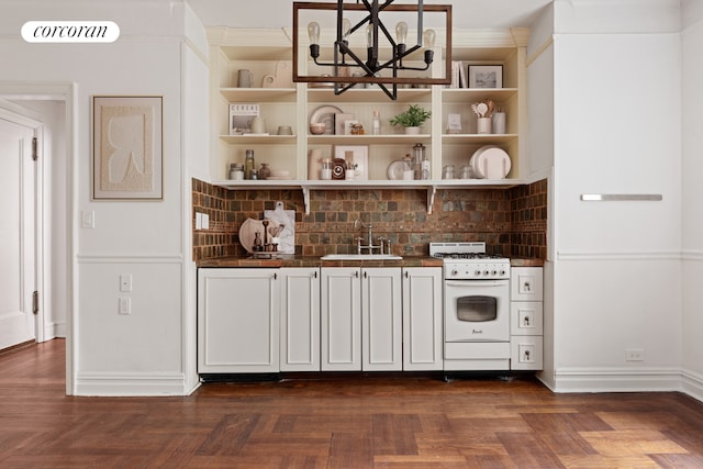 kitchen featuring a sink, crown molding, white gas range, decorative backsplash, and open shelves