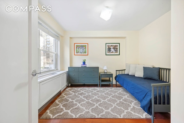 bedroom with dark wood-style floors