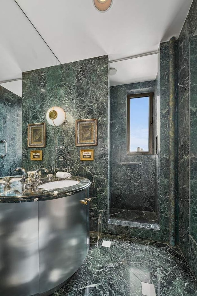 bathroom featuring walk in shower and vanity