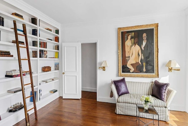 living area featuring crown molding, baseboards, and wood finished floors