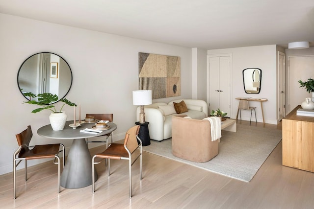 living area featuring light wood-type flooring and baseboards