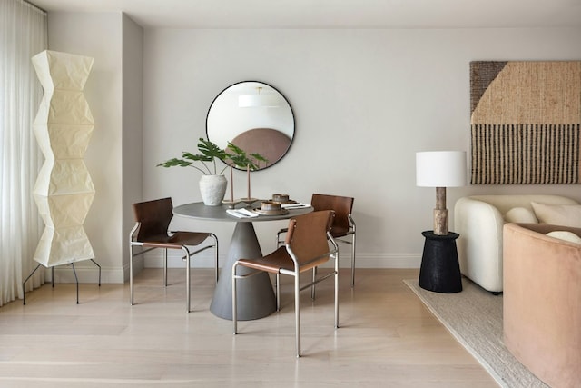 sitting room featuring light wood-type flooring and baseboards