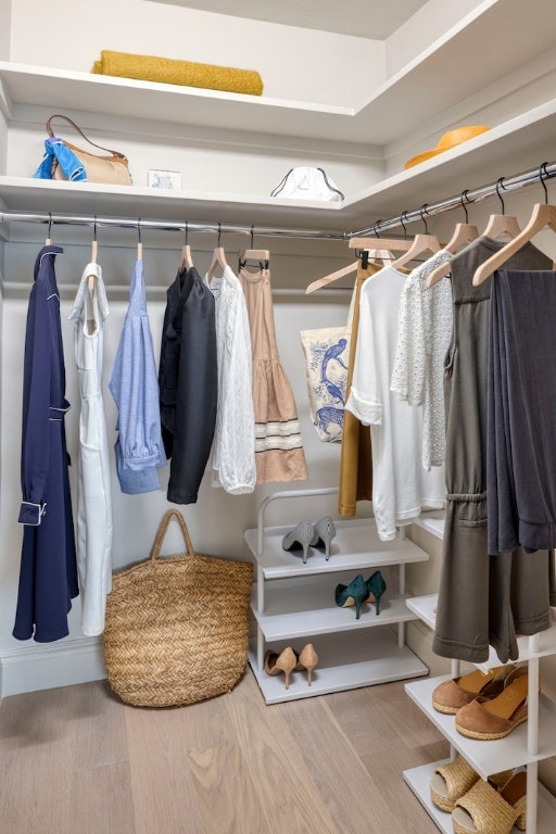 walk in closet with wood finished floors