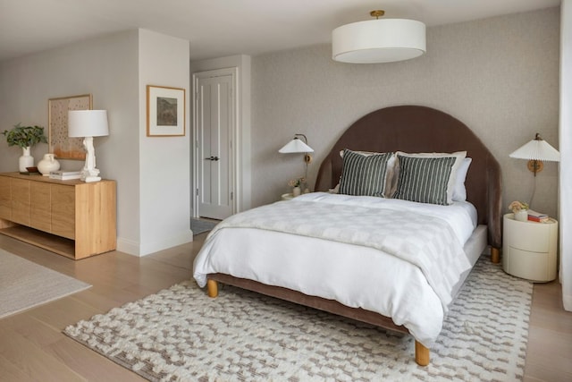 bedroom featuring baseboards and wood finished floors