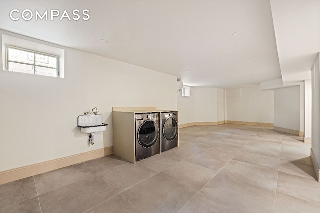 laundry area with laundry area, independent washer and dryer, baseboards, and tile patterned floors