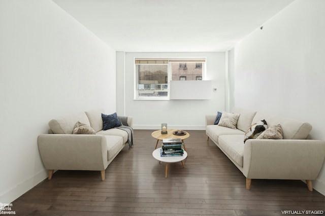 living room featuring baseboards and hardwood / wood-style flooring