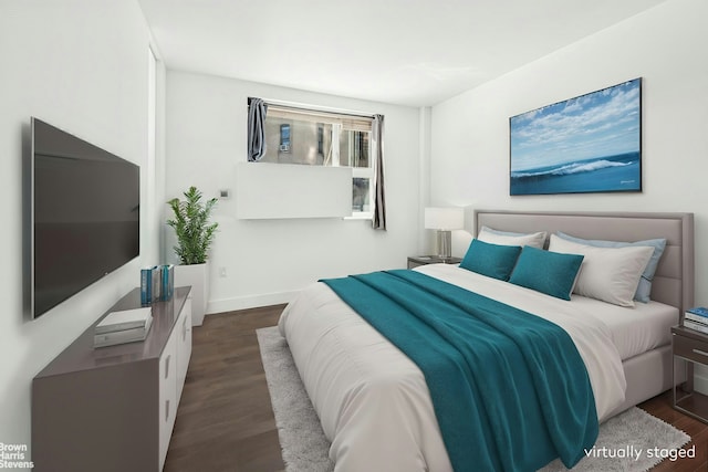 bedroom featuring baseboards and dark wood finished floors