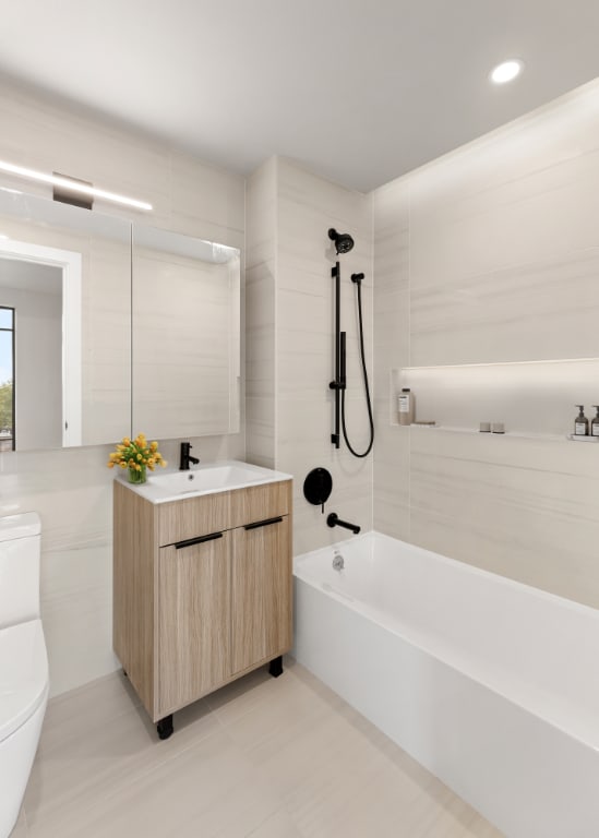 bathroom featuring toilet, bathtub / shower combination, vanity, tile walls, and recessed lighting