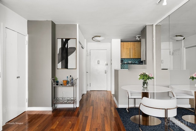 interior space with baseboards and dark wood-style flooring