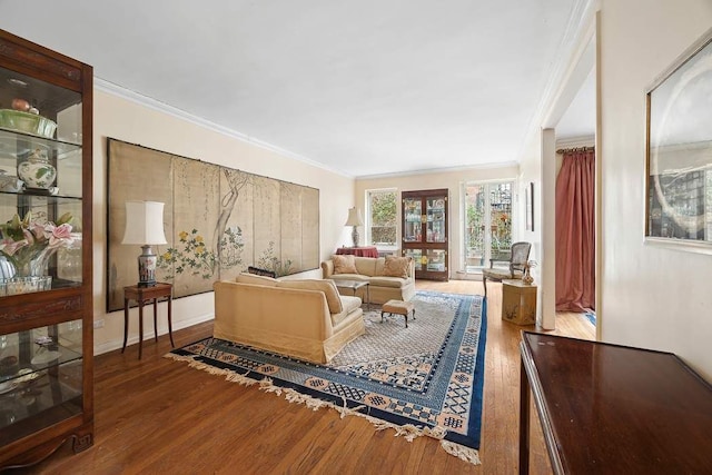 living area featuring ornamental molding and wood finished floors