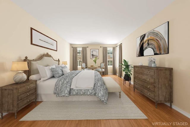 bedroom featuring baseboards and light wood-style floors