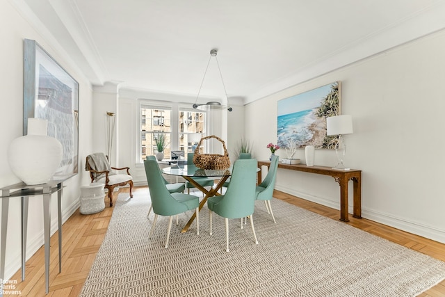 dining room with baseboards and ornamental molding