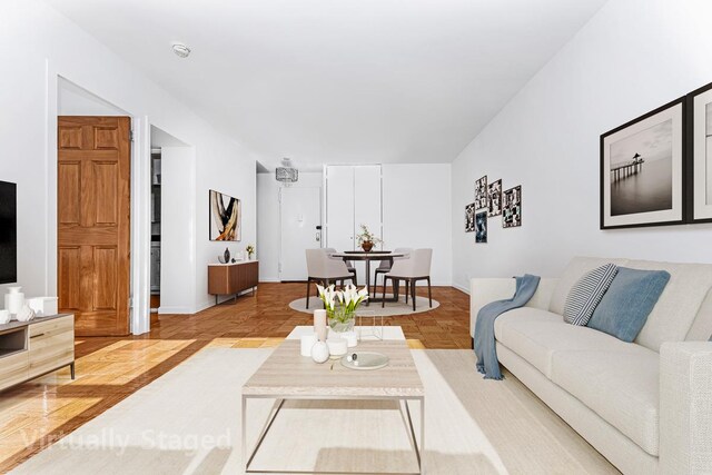 living area featuring baseboards