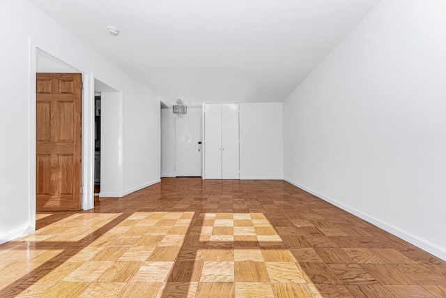 unfurnished room featuring baseboards