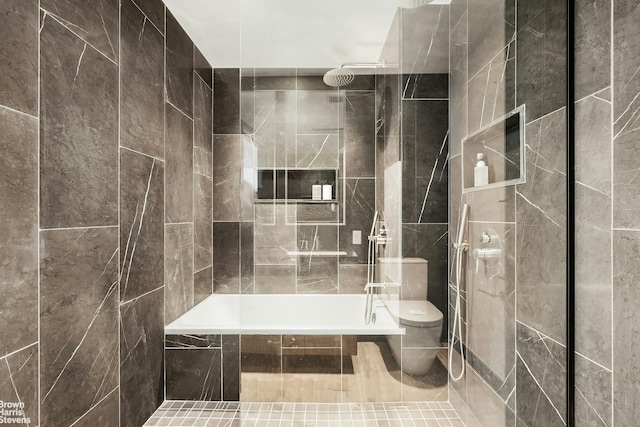 bathroom with a tub to relax in, a tile shower, and toilet