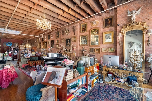 misc room with an inviting chandelier and brick wall