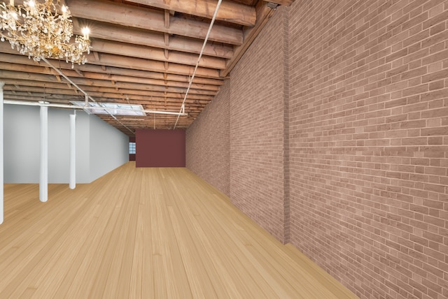 basement featuring brick wall and wood finished floors