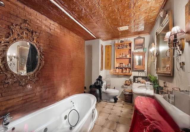 bathroom featuring an ornate ceiling, toilet, vanity, brick wall, and a whirlpool tub