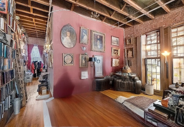 miscellaneous room with wood finished floors and a towering ceiling