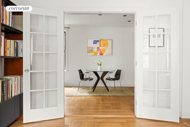 interior space featuring baseboards and french doors