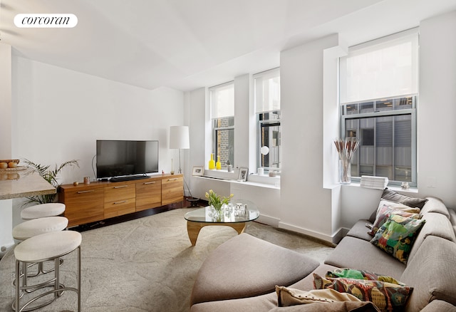 carpeted living room featuring visible vents and baseboards