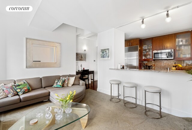 carpeted living room with visible vents and baseboards