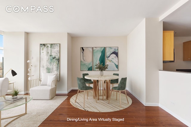 dining room featuring baseboards and wood finished floors