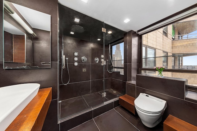 full bathroom with a stall shower, tile patterned floors, and toilet