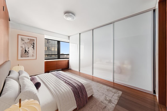 bedroom featuring wood finished floors and a closet