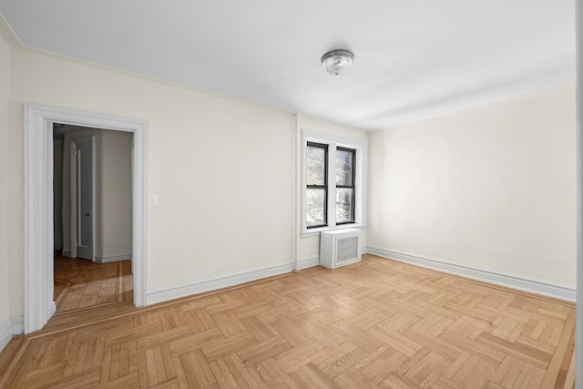 spare room featuring baseboards