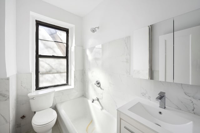 bathroom with a bath, toilet, vanity, and tile walls