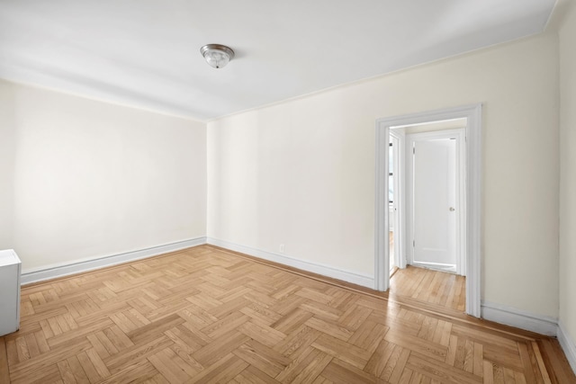 spare room with baseboards