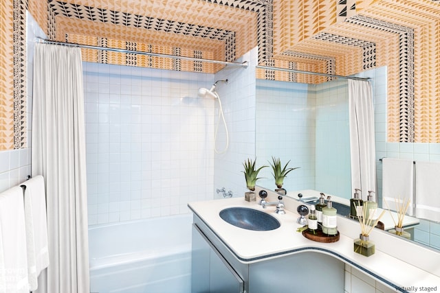 bathroom featuring shower / tub combo, vanity, and tile walls