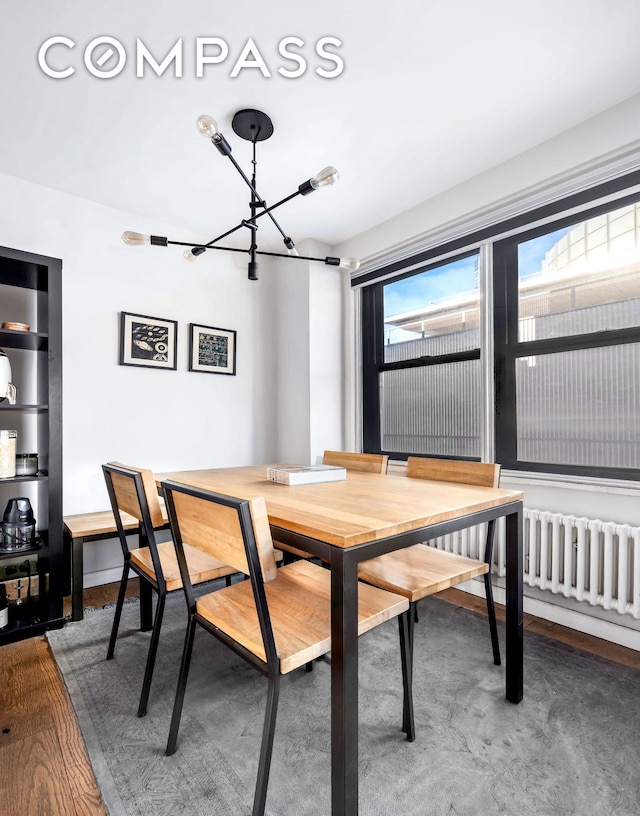 330 3rd Ave Unit 20A, New York City, NY 10010 - dining space featuring a chandelier and wood finished floors