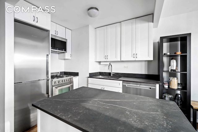 330 3rd Ave Unit 20A, New York City, NY 10010 - kitchen featuring high quality appliances, white cabinets, and dark stone counters