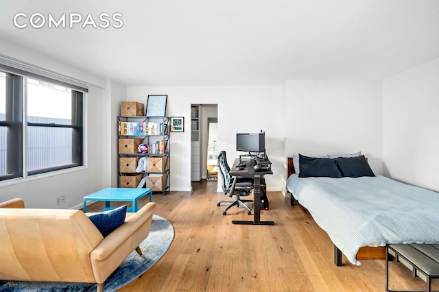 bedroom featuring baseboards and light wood-style flooring