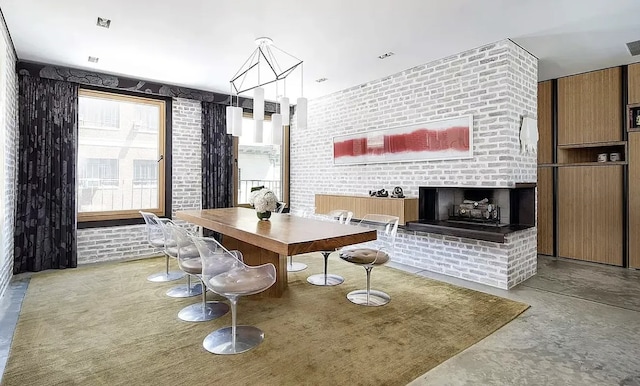 75 Warren St, New York City, NY 11201 - dining room featuring finished concrete flooring, brick wall, a fireplace, and visible vents