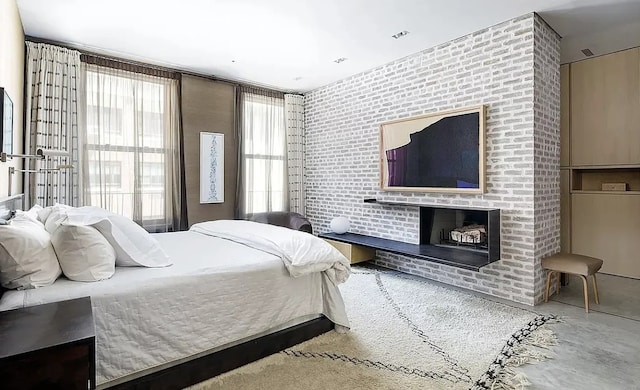 75 Warren St, New York City, NY 11201 - bedroom with a brick fireplace, visible vents, and concrete floors